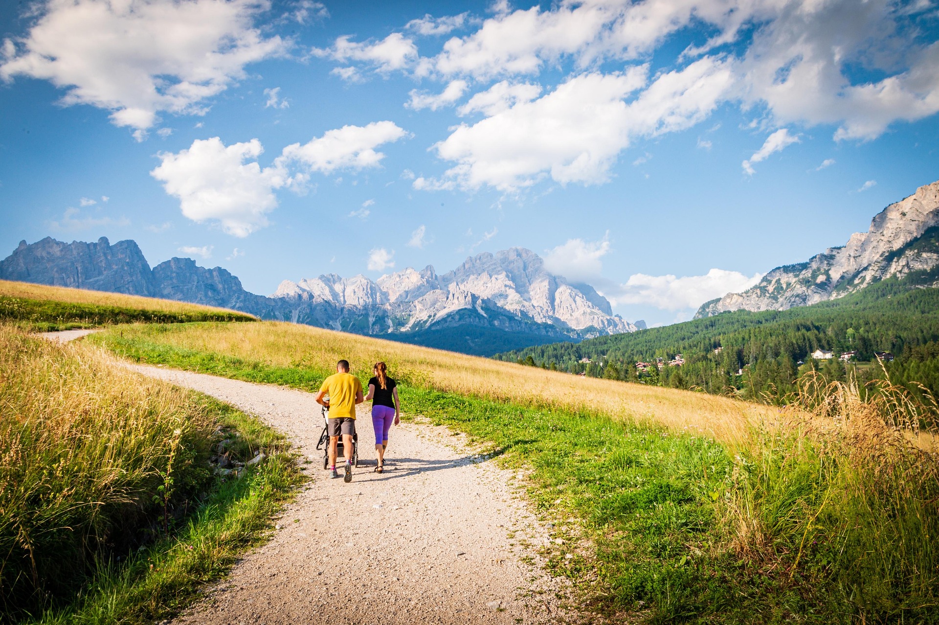 Two people walking a mountain trail together